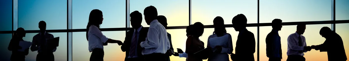 Group of people working together in an office meeting while standing
