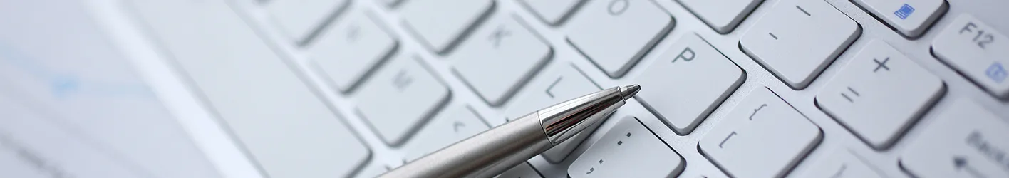 Pen lying on a keyboard