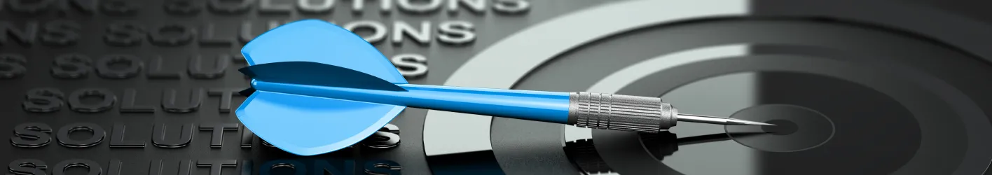 Dart laying on the bulls-eye next to the words solutions