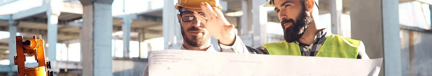 Two engineers discussing building plans