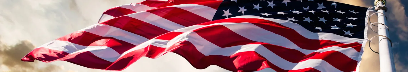 A large American Flag flying in the wind