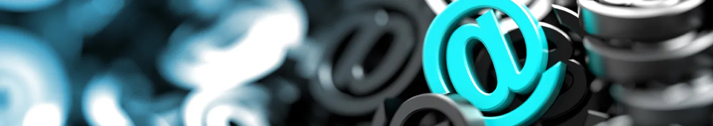 Picture of several 3D @ symbols. One is teal.