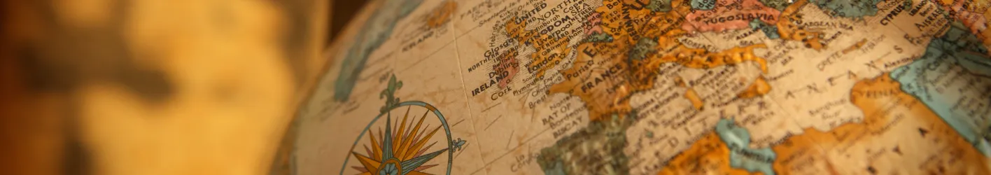 Picture of a globe and background, mostly yellow and orange 