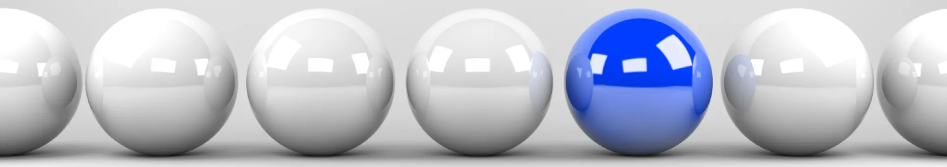 Picture of bland color balls with one being blue.