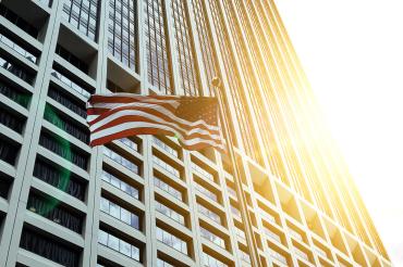 Building with American flag flying nearby