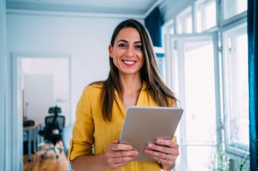 Lady in Yellow shirt with a tablet in hand